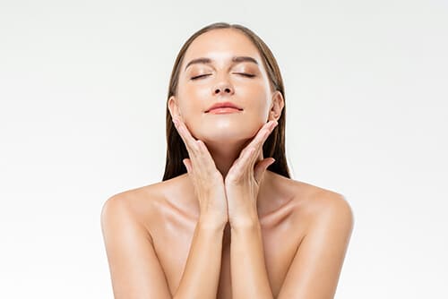 Beautiful Caucasian woman with clean glowing face skin in isolat