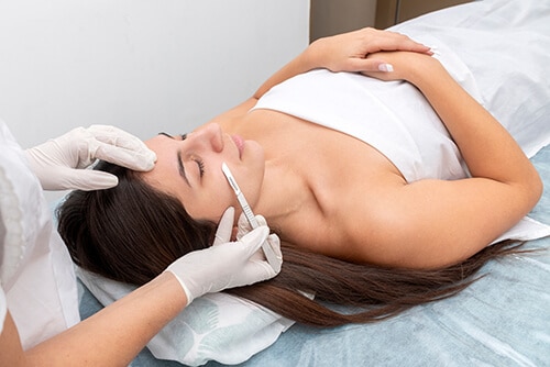 young woman in a beauty center performing a beauty treatment for