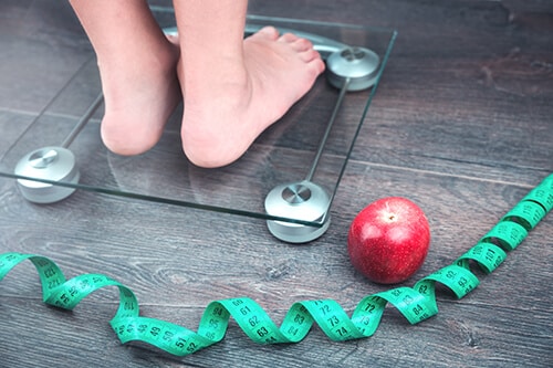 Tape measure, apple and weighing scale