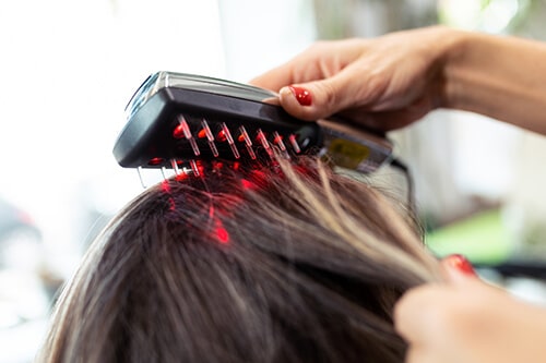 Hairdresser doing a treatment with ultrasonic and infrared laser