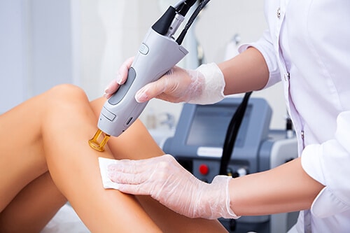 Close-up of a female cosmetologist in a medical coat making a yo